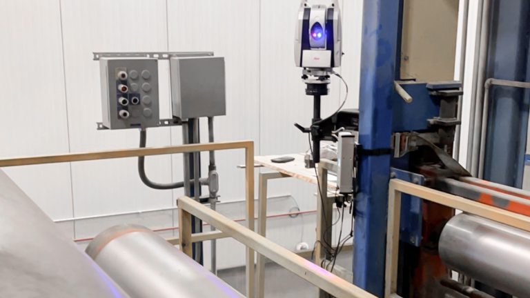 Laser roll alignment: a laser tracker measuring roll parallelism on a continuous shingle line, laser beam visible along the roll face